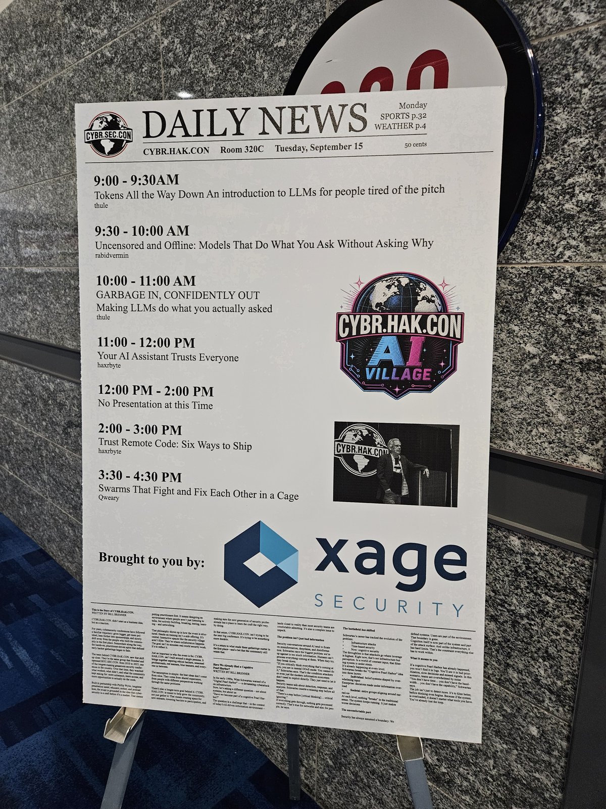 A mock newspaper front page printed as the AI village schedule board, mounted on an easel in a convention center hallway.